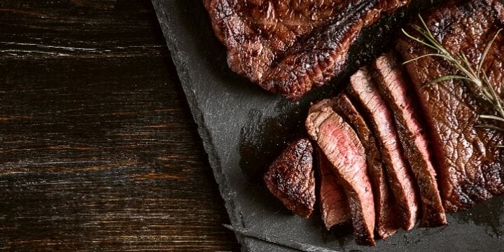 Air fryer beef steak sliced on a board