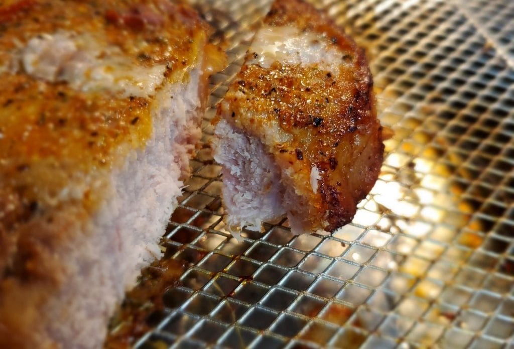 air fryer pork chops with a bite sliced off