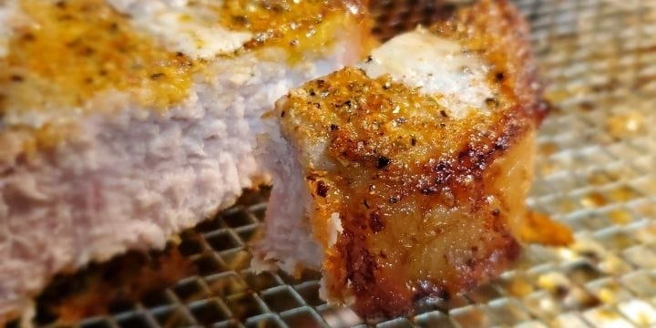 crispy Air fried pork chop sliced showing tender meat inside