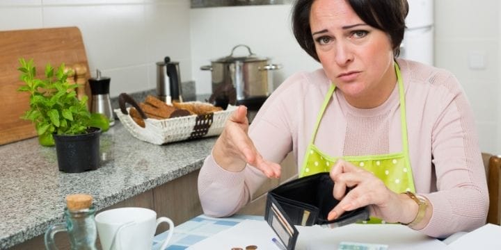 woman pointing at empty wallet