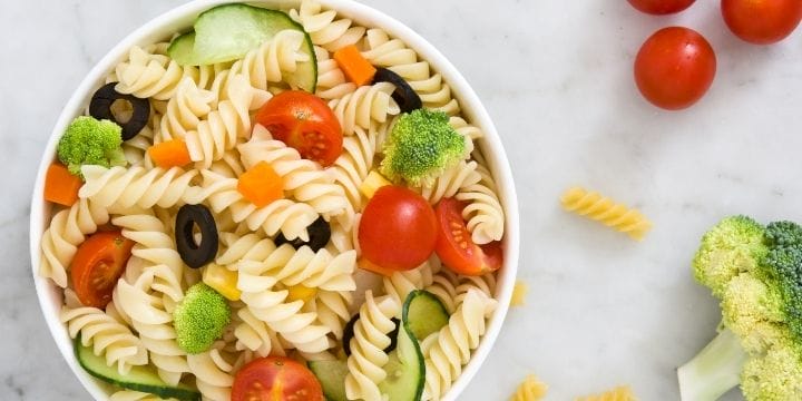 cold pasta salad with veggies on a board