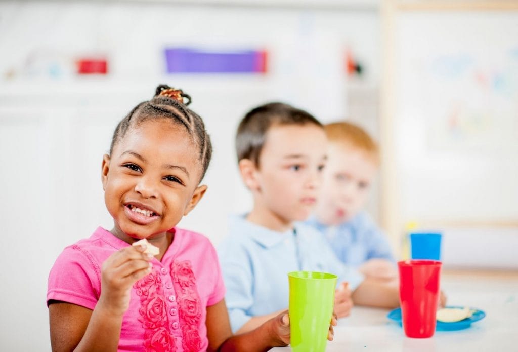 kids at a table eating daycare snacks