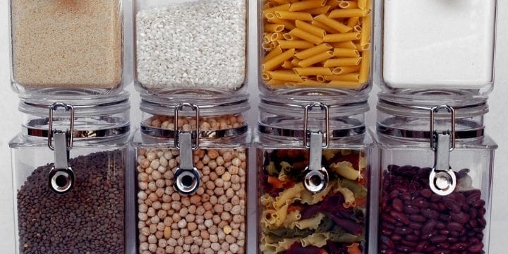 rows of jars full of beans and pasta for cooking