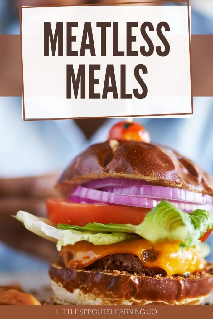 Meatless burger full of veggies on a plate topped with a roasted cherry tomato