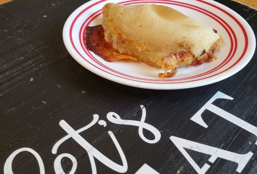 meatless hot pocket on a plate on a board that says let's eat