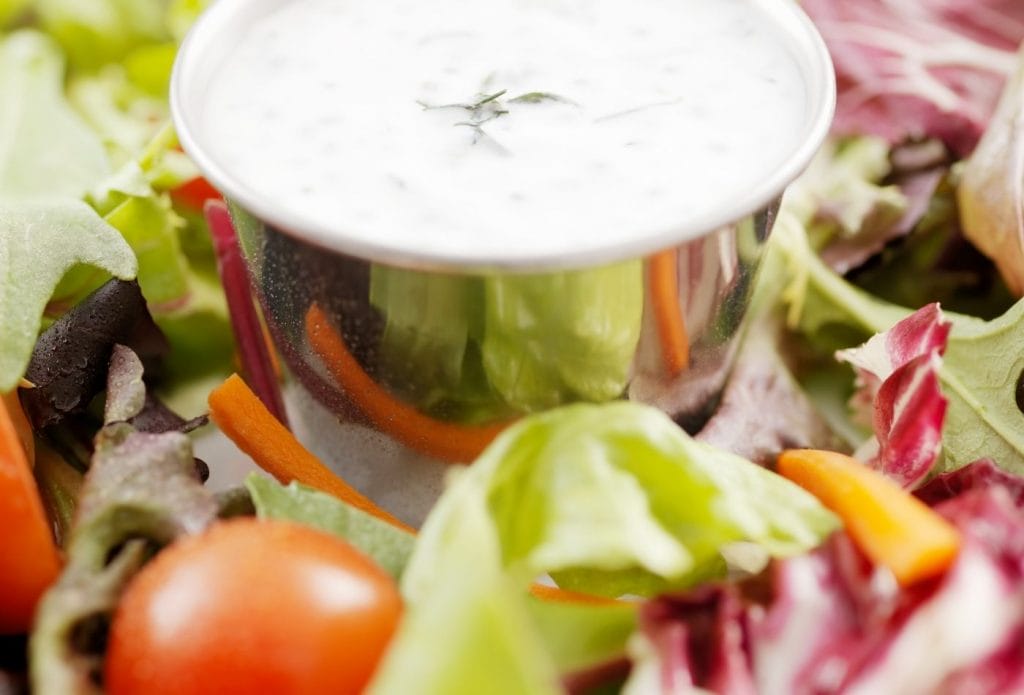 cucumber salad dressing in a bowl on a salad plate
