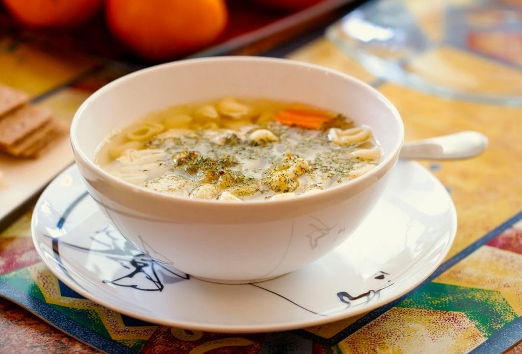 bowl of soup on a plate on the table