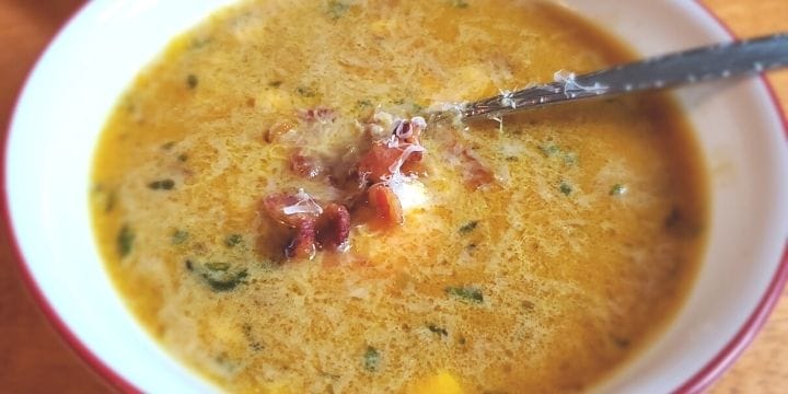 butternut squash soup in a bowl with a spoon