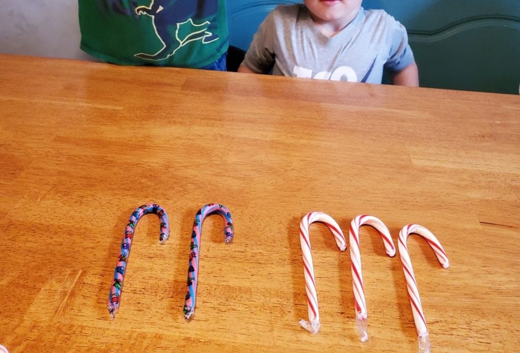 candy canes lined out on the table for counting and sorting