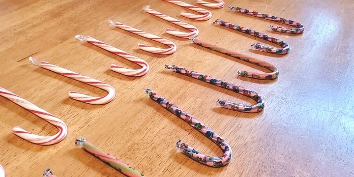 candy canes lined up in rows on the table for counting