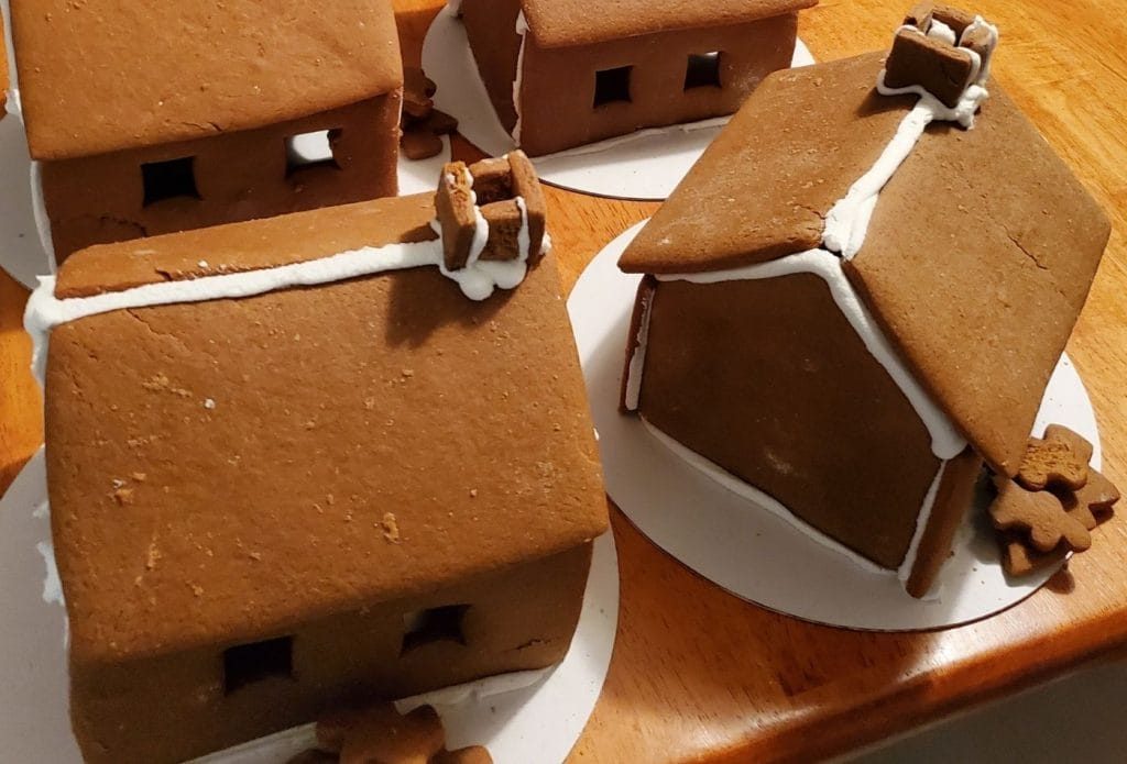 Homemade gingerbread houses glued to boards ready to decorate