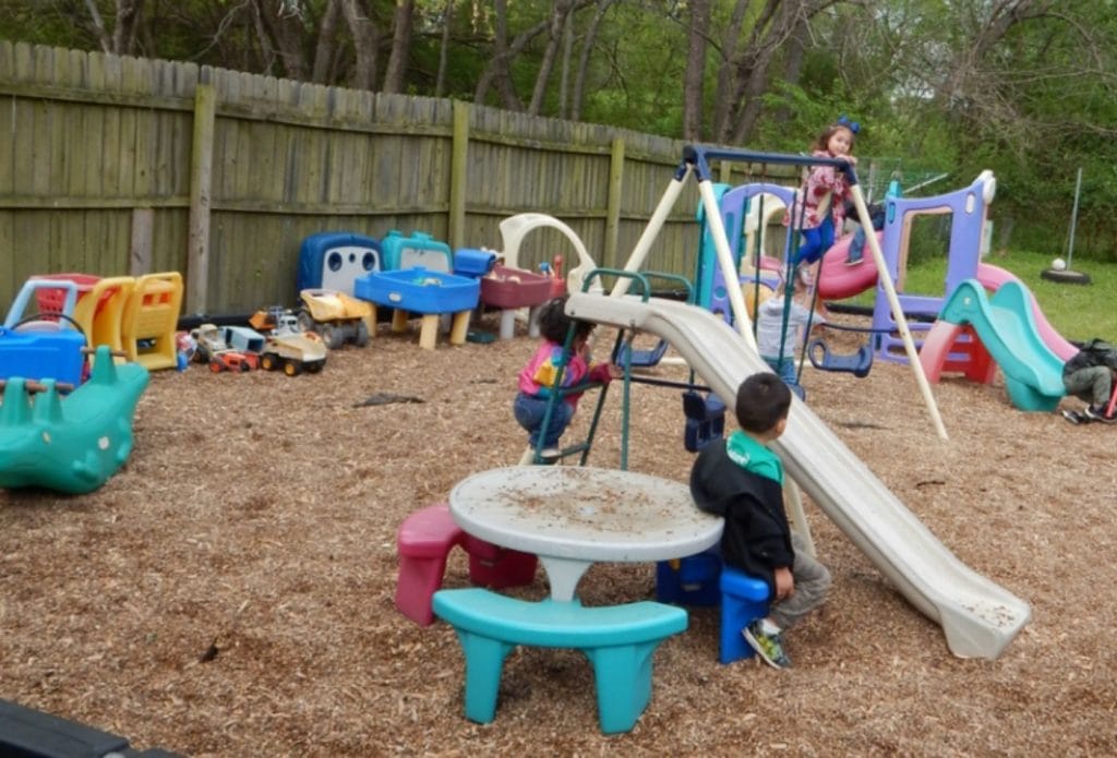 kids happily playing outside in home daycare