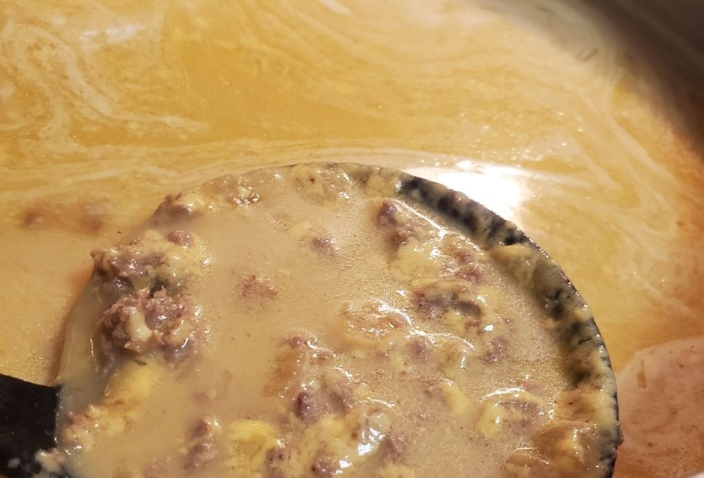 keto bacon cheeseburger soup in a pot with a ladle