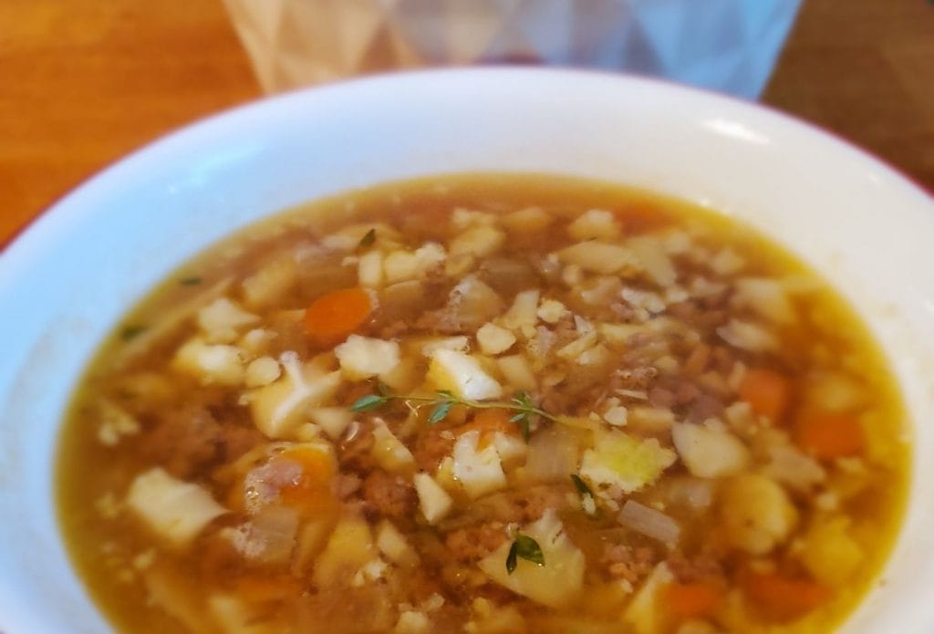 hamburger cauliflower soup in a bowl on the table with a pot
