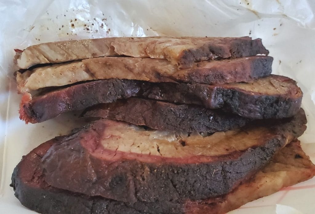 leftover smoked brisket meat in a take out container