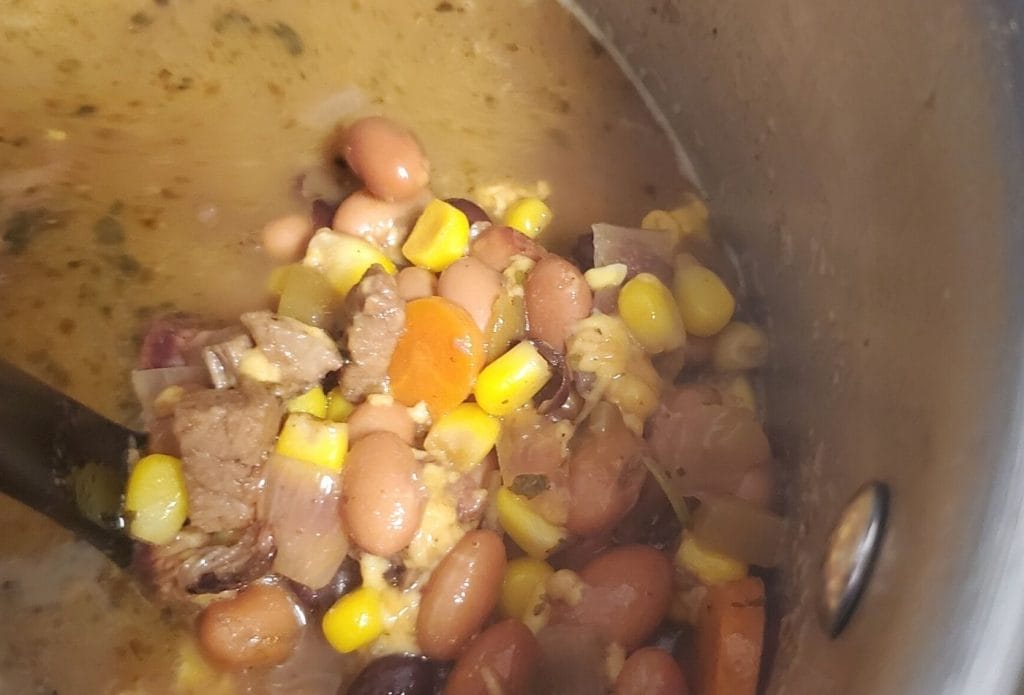 Mexican leftover smoked brisket soup in a pan on the stove