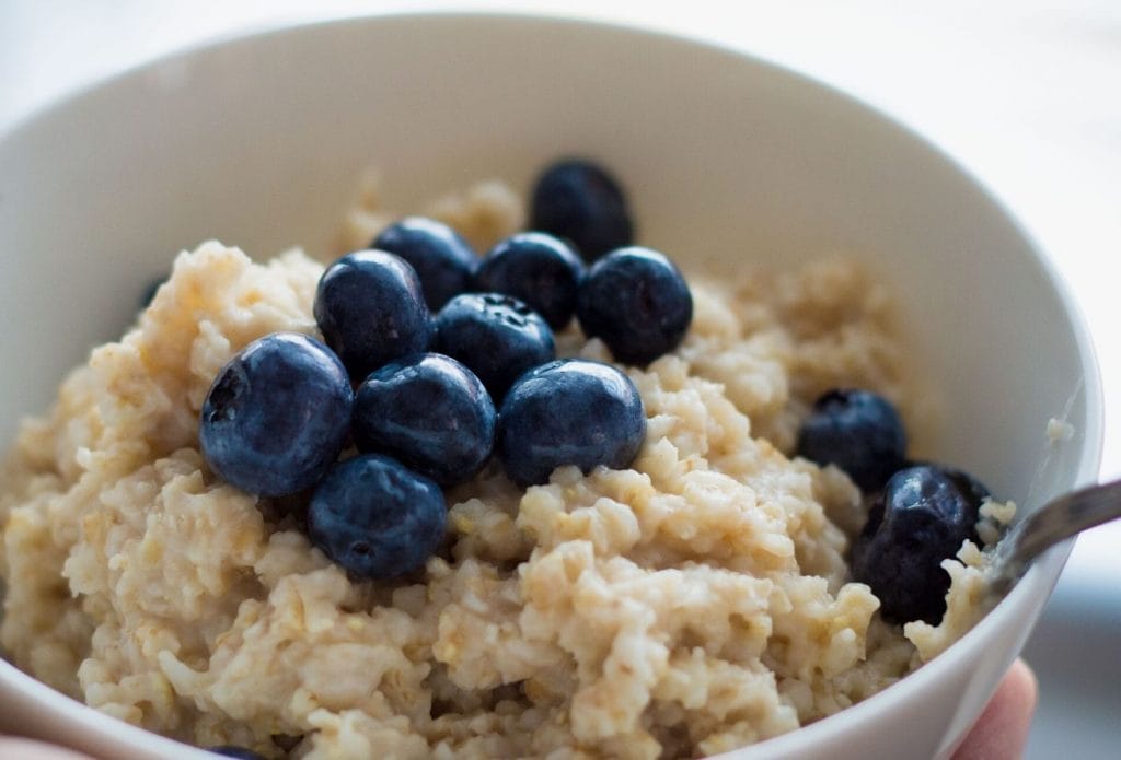 bowl of creamy oatmeal with blueberries