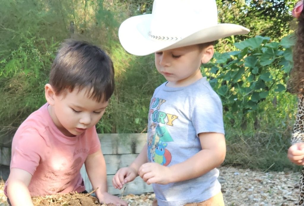 kids in a home daycare planting seeds in the preschool garden