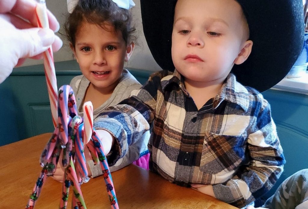 kids doing a candy cane activity in home daycare with their daycare provider