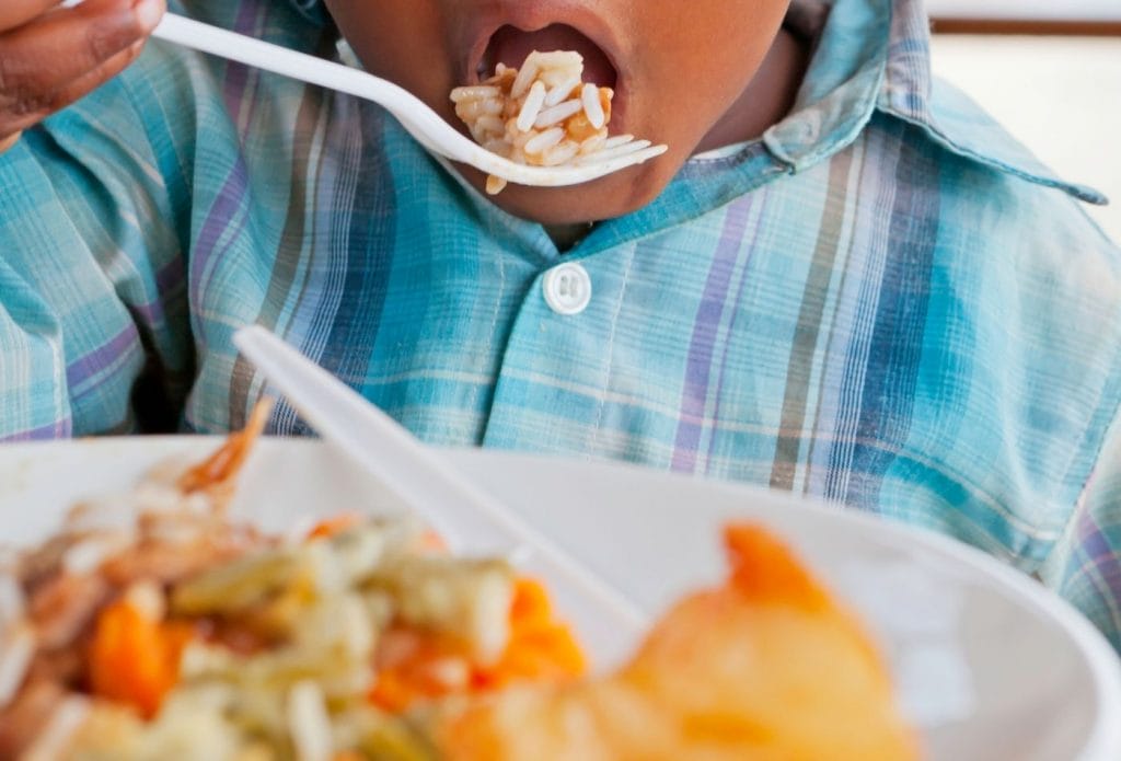 child eating healthy food with a fork