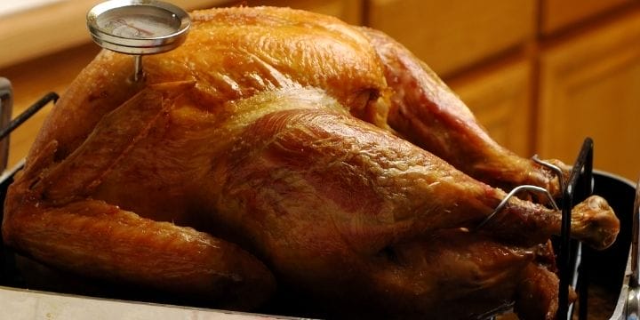 brown roasted turkey in a roasting pan
