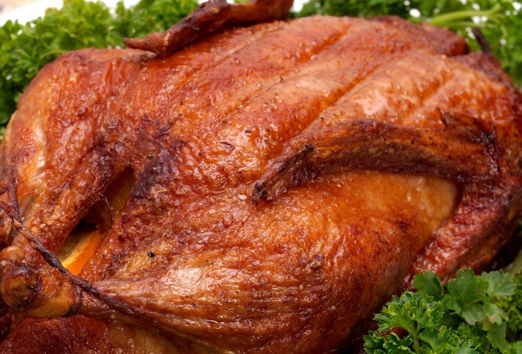 dark roast crispy skinned duck on a plate with lettuce