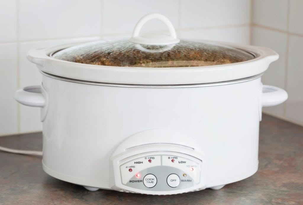 crockpot full of chili sitting on a counter