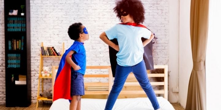 confident kids playing superheroes
