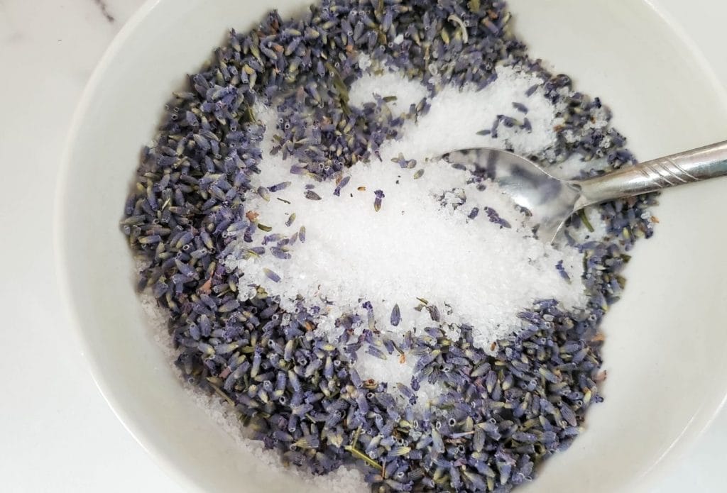 lavender buds in a bowl with Epsom salts and a spoon