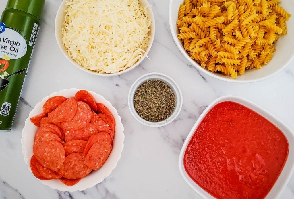 ingredients for pepperoni pizza bake on a board