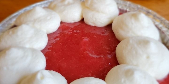 mini cranberry tart topped with homemade whipped cream
