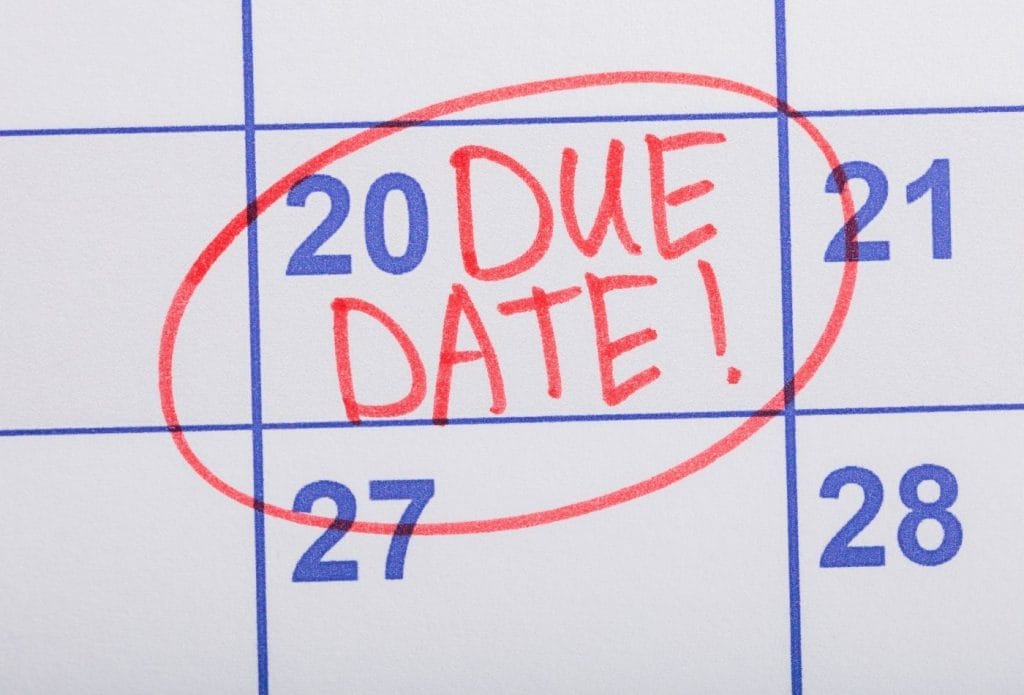 calendar page with due date written in red on the 20th and circled