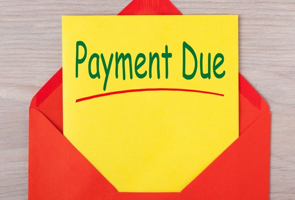 red envelope with yellow sheet that says payment due on it