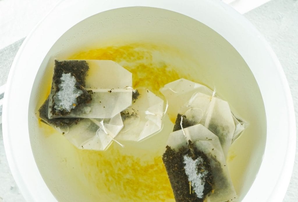 white bowl with tea steeping in water
