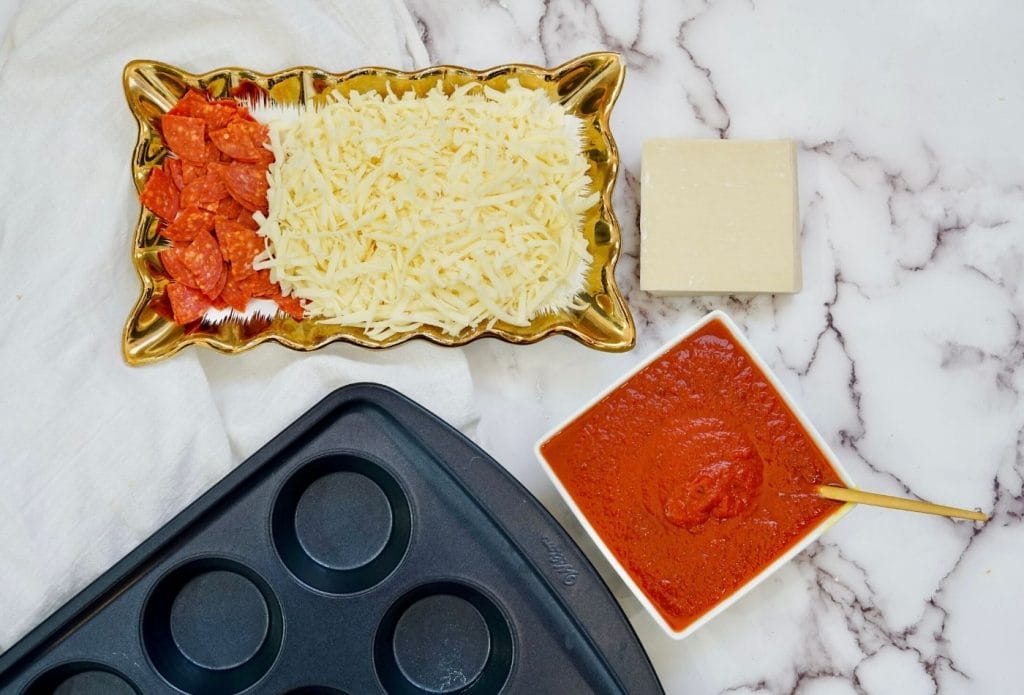 pepperoni pizza cup ingredients, pizza sauce, wonton wrappers, shredded mozzarella and pepperoni