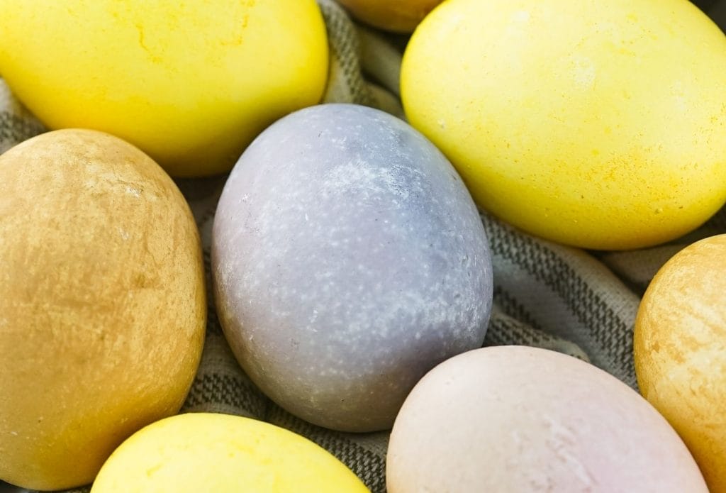 brightly colored naturally dyed easter eggs on a towel