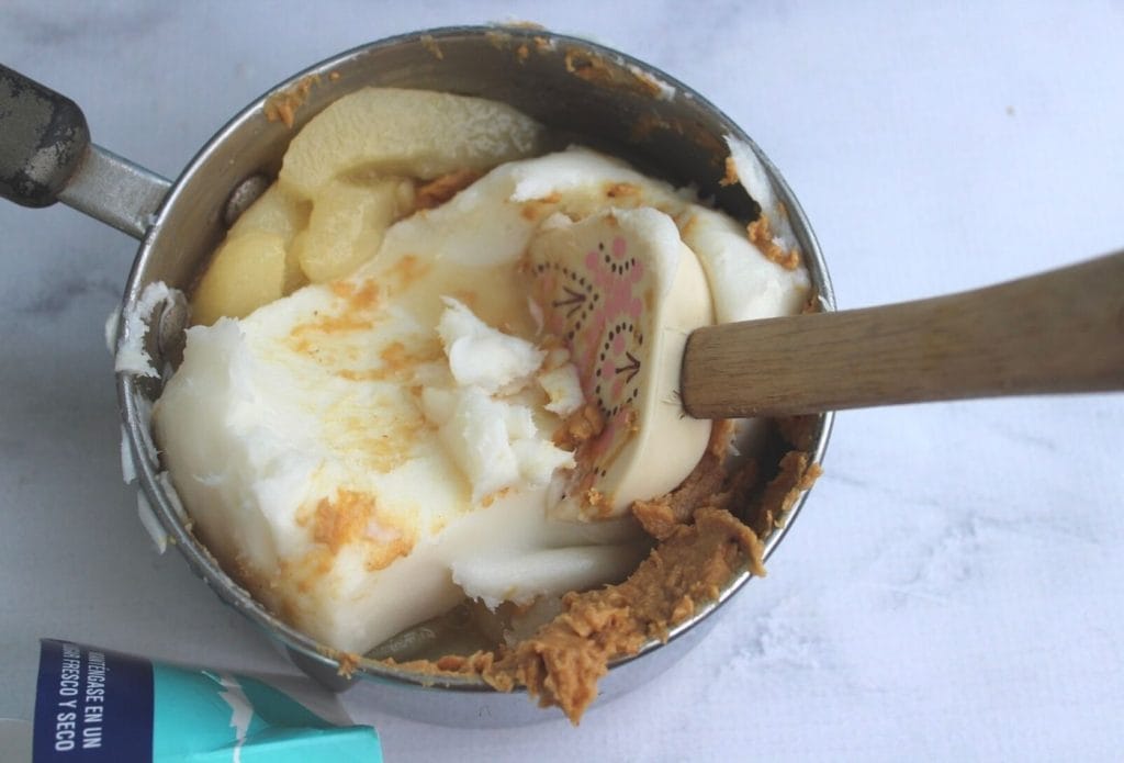 suet cake ingredients being mixed together in a saucepan with a spatula
