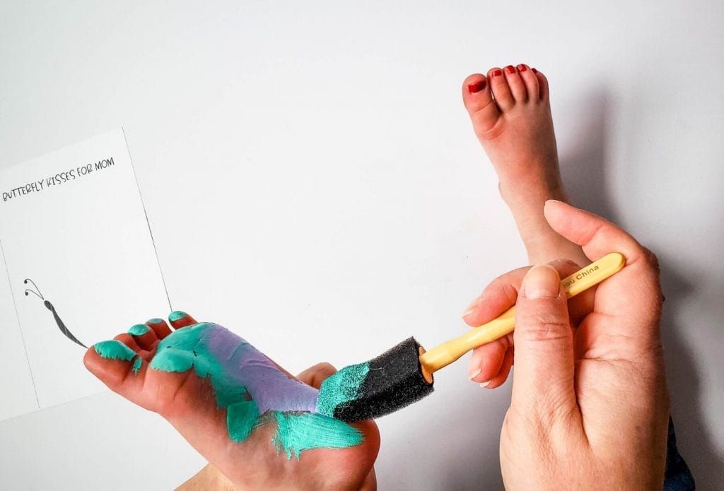 hand painting baby's foot bottom with foam brush