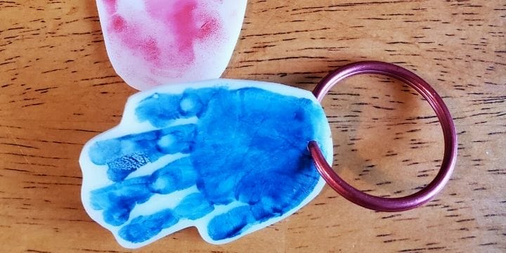 shrinky dink hand print keychains organized on a table