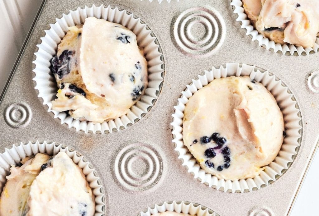 blackberry muffins in a muffin tin ready to bake