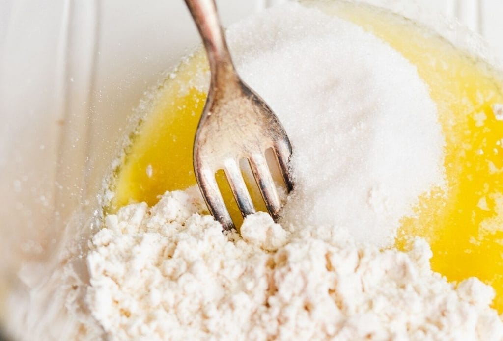 muffin ingredients in a bowl with a fork