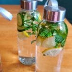 infused waters on the table with cucumbers, mint, and lemon