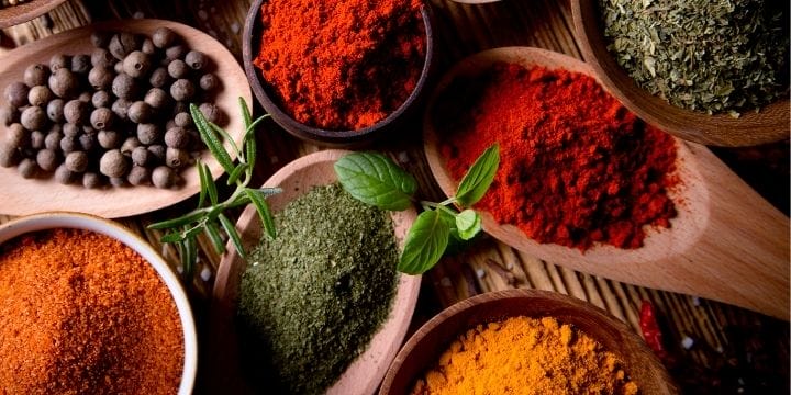 spices in spoons arranged on a board