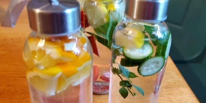 infused waters on the table in bottles with fruit and herbs