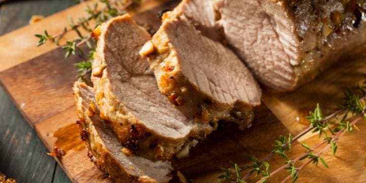 thick slices of air fried pork tenderloin on a board
