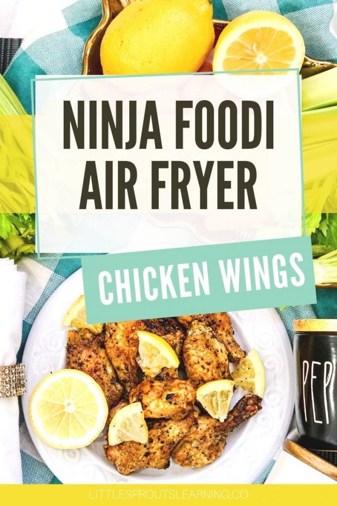 Chicken wings from the ninja foodi air fryer on a plate with lemons and pepper
