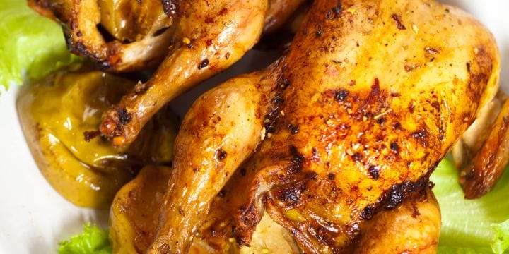 air fryer cornish hens on a plate with roasted apples
