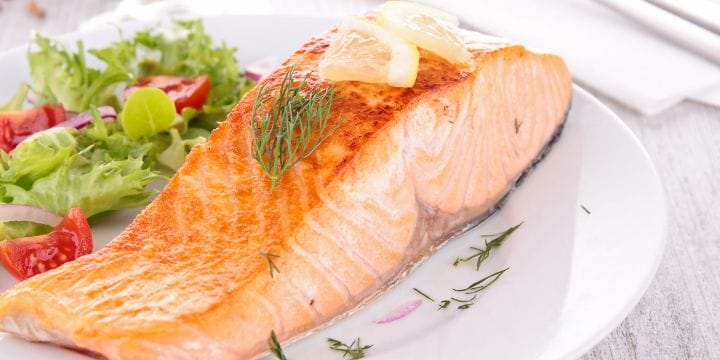 plate with salmon fillet and salad