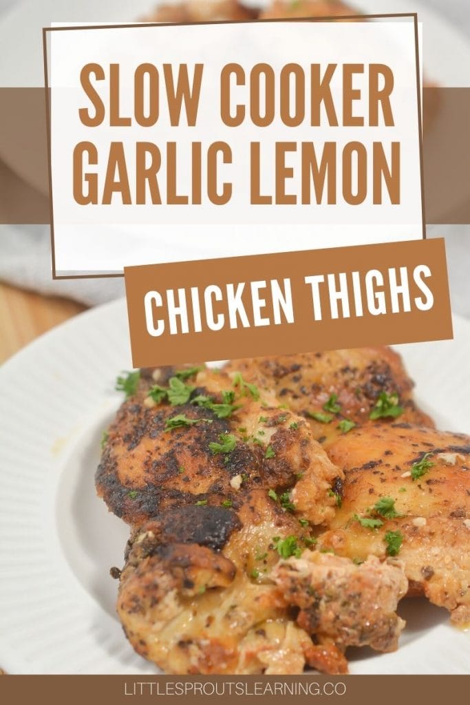 slow cooker garlic lemon chicken thighs on a white plate garnished with herbs