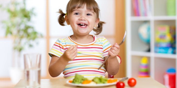 young child eating veggies